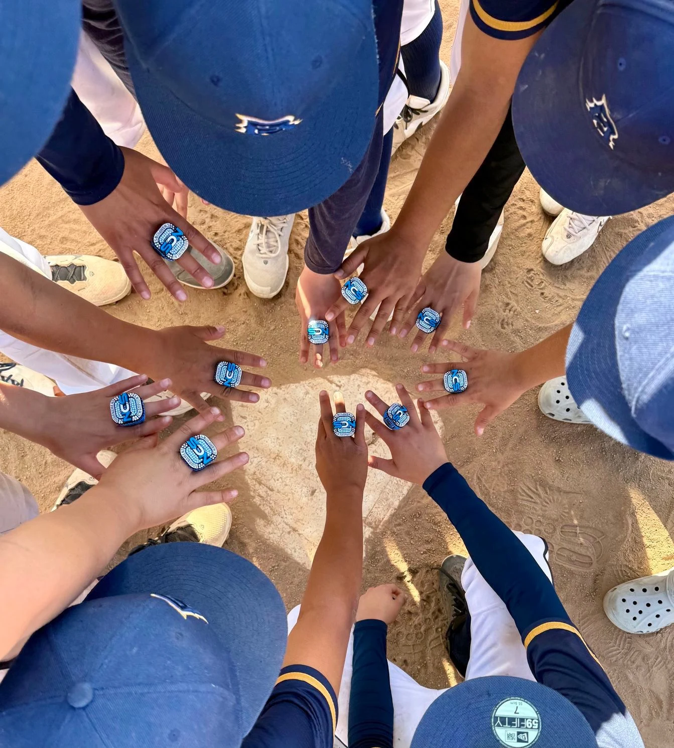 PA players bringing their hands together in a team huddle